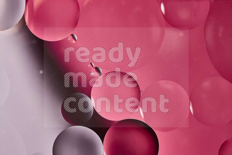 Close-ups of abstract oil bubbles on water surface in shades of white and pink