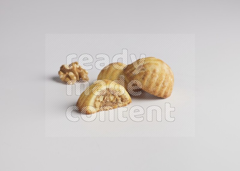 Three Pieces of Maamoul filled with walnut paste  one of them is cut direct on white background