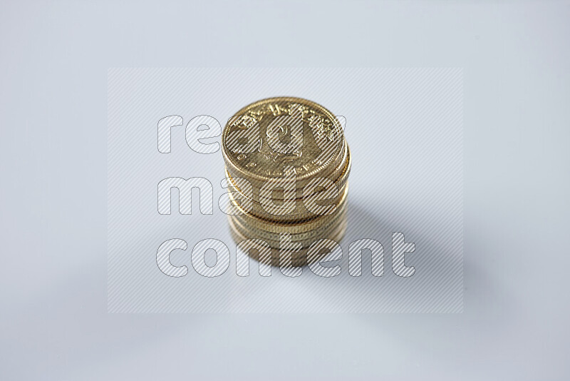 Stack Egyptian 50 piasters coins on grey background