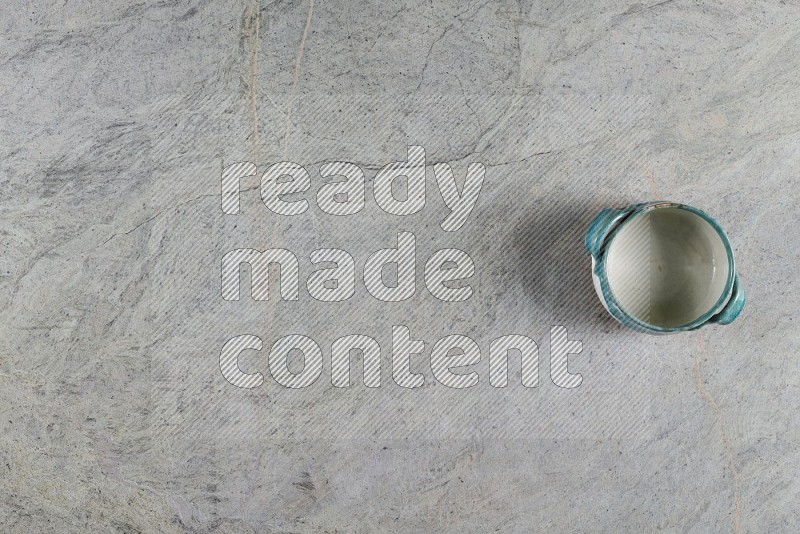 Top View Shot Of A Multicolored Pottery Bowl On Grey Marble Flooring