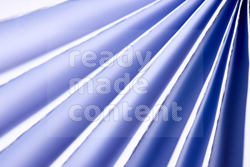 An image presenting an abstract paper pattern of lines in blue and white tones