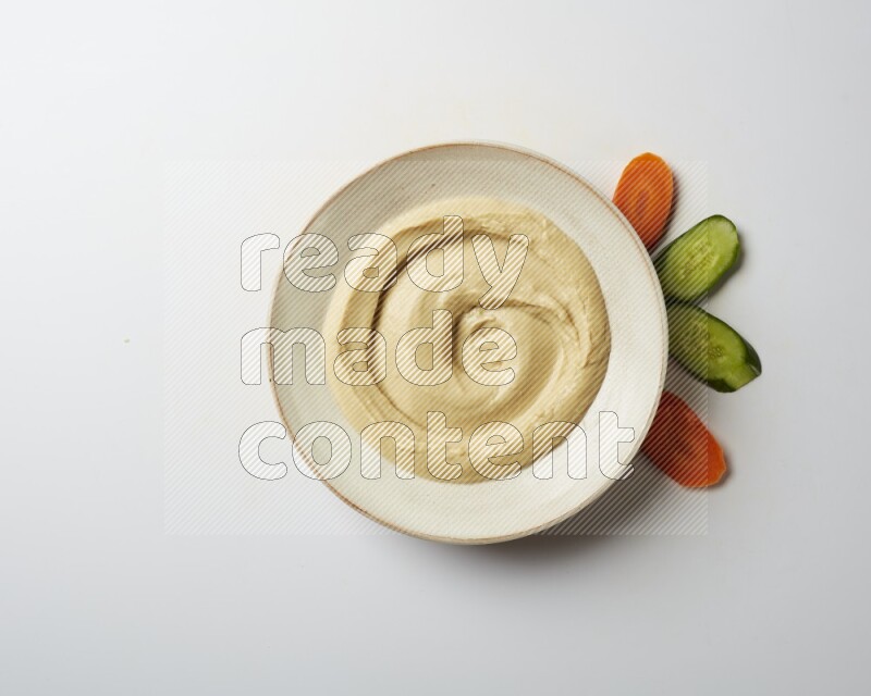plain Hummus in a pottry plate  on a white background