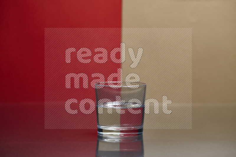 The image features a clear glassware filled with water, set against red and beige background