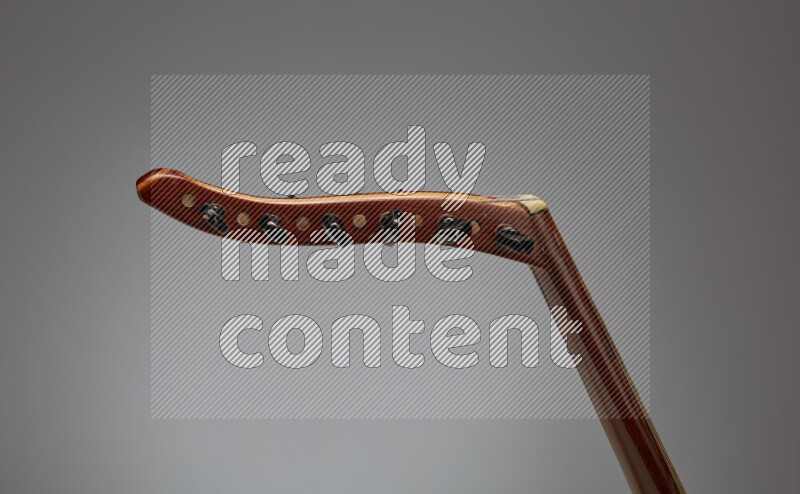 parts of a brown wooden Oud in a gray background