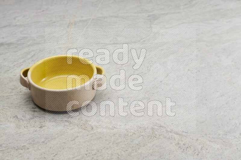 A multicolored pottery bowl on grey marble background