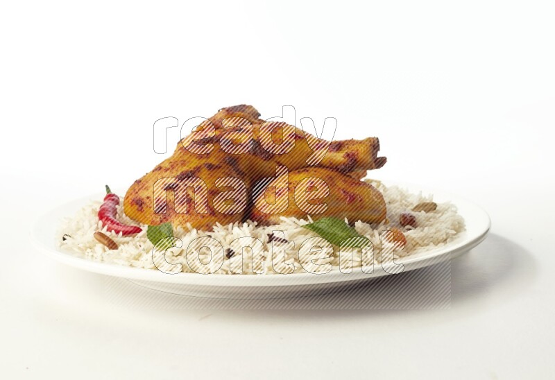 white  basmati Rice with  kabsa chicken pieces  on a white rounded plate direct on white background