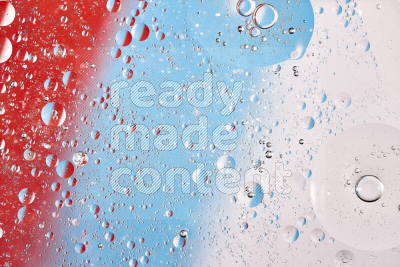 لقطات مقربة لفقاعات من الزيت على سطح الماء باللون الأحمر والأبيض والأزرق