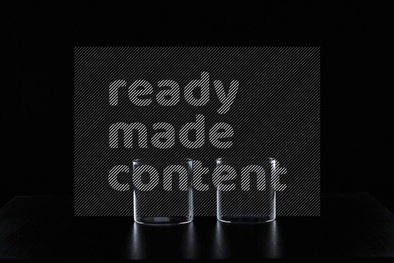 Glassware with rim light against black background