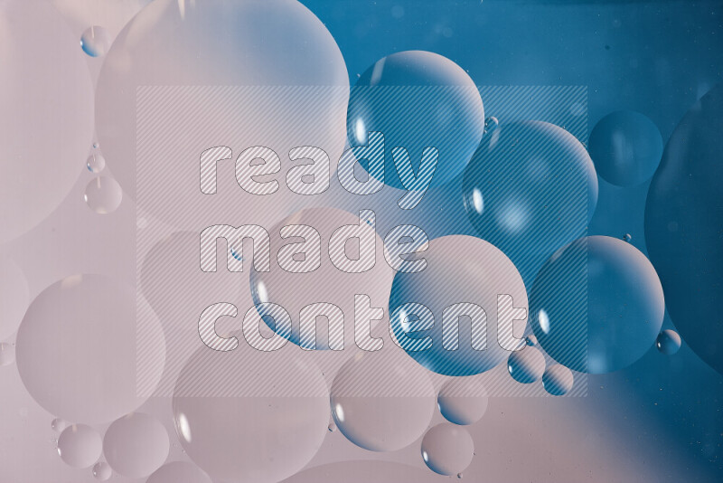 Close-ups of abstract oil bubbles on water surface in shades of white and blue