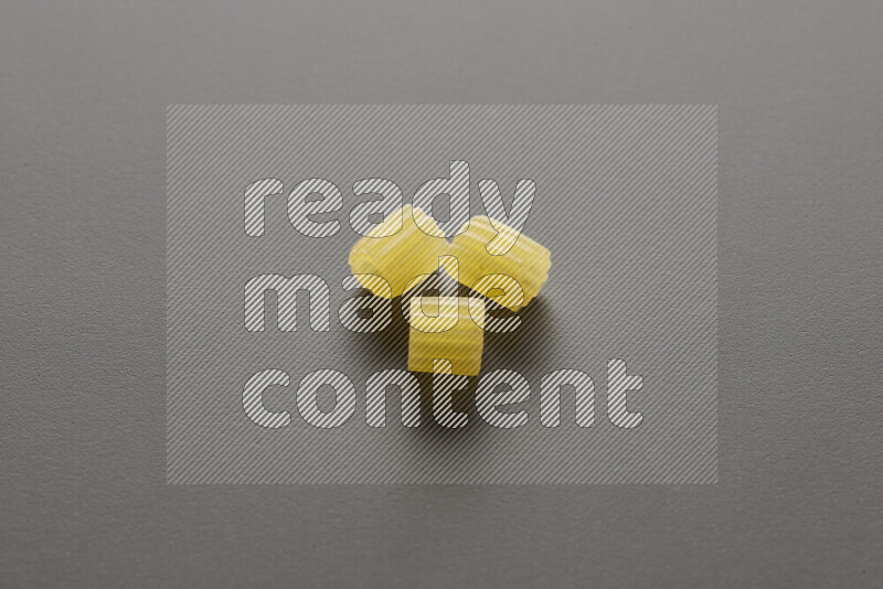 Small rings pasta on grey background