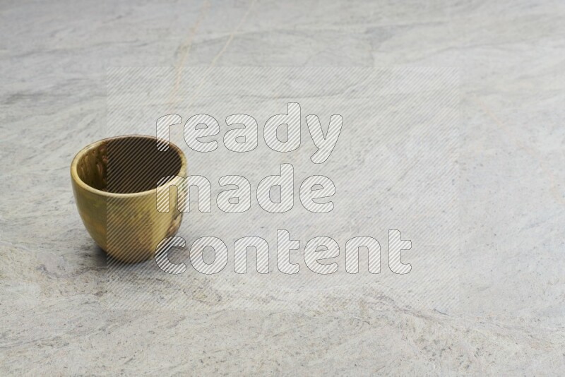 A multicolored pottery Cup on grey marble background
