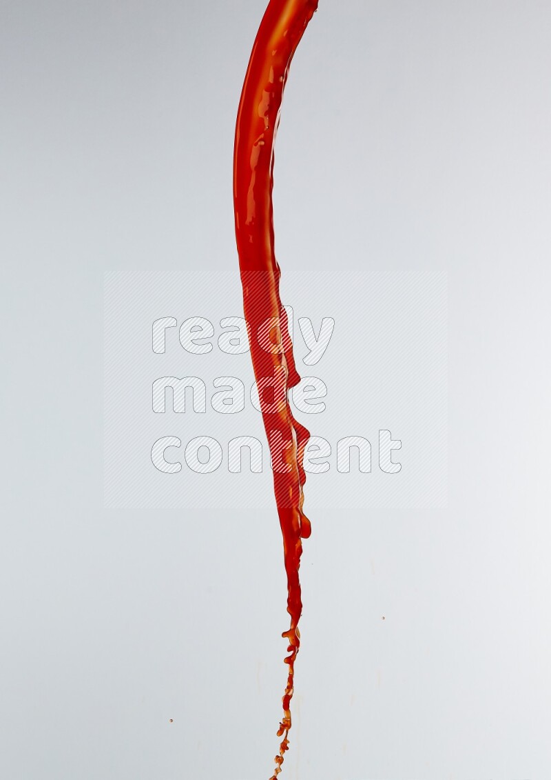 Orange liquid splash and drops on white background