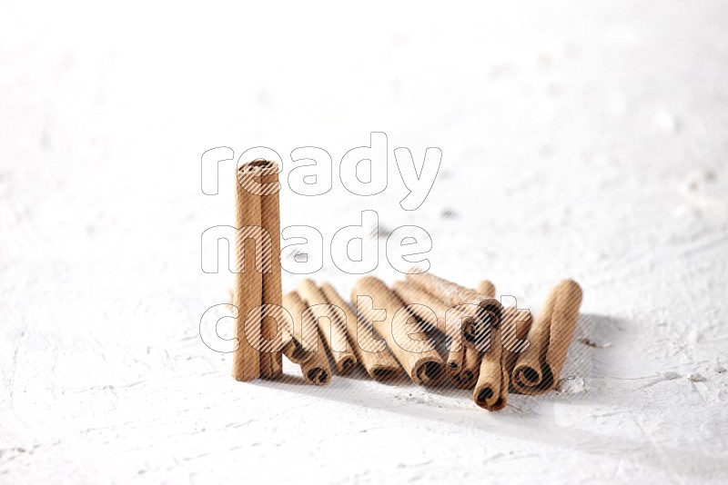 Cinnamon sticks on a textured white background