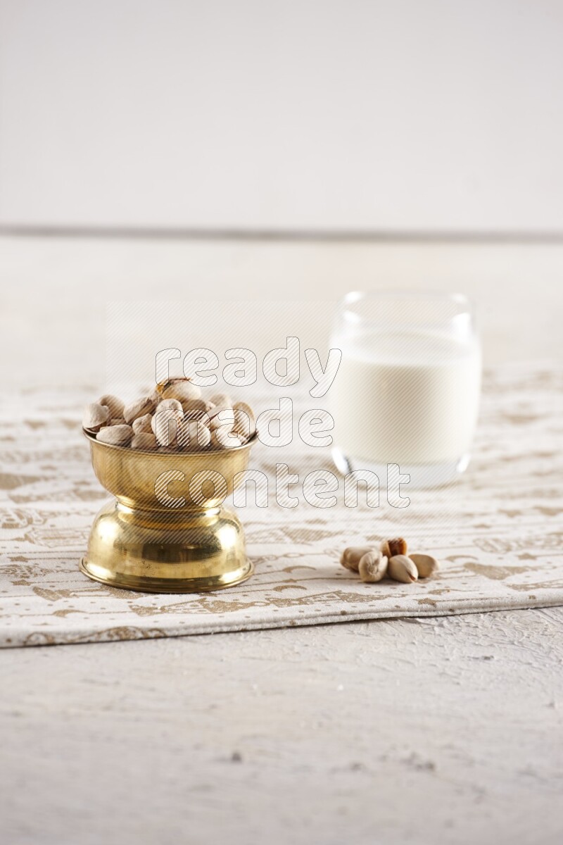 Nuts in a metal bowl with milk a light setup