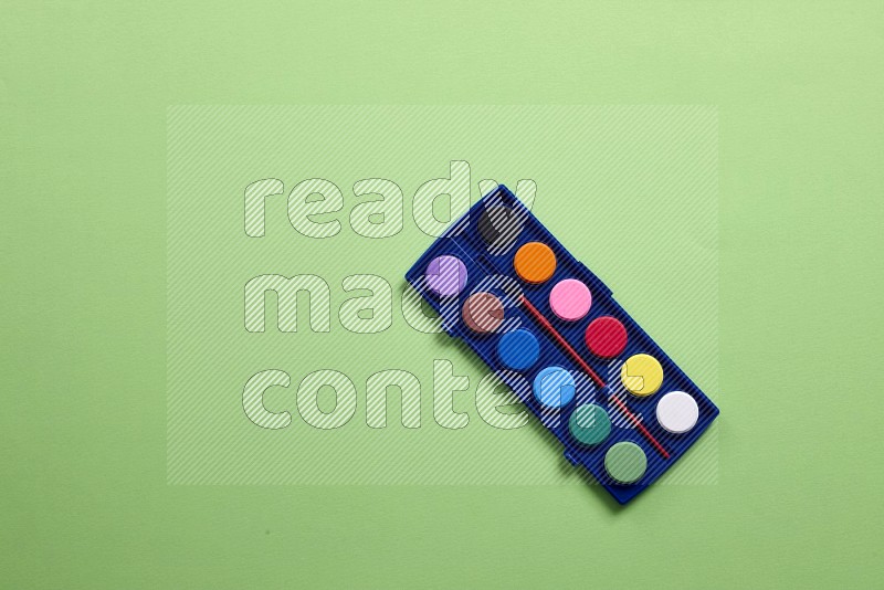Watercolor paint set on green background (back to school)