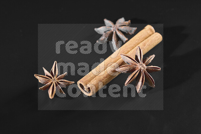 Cinnamon sticks and star anise on black background