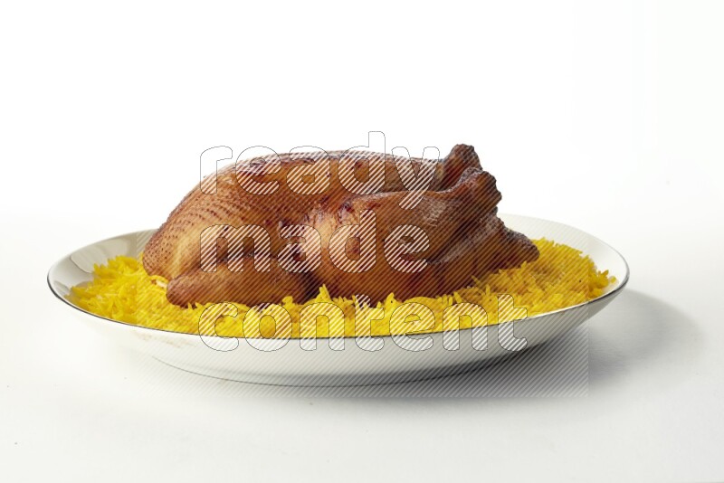 yellow  basmati Rice with kabsa chicken pieces on a white plate with a silver rim direct on white background