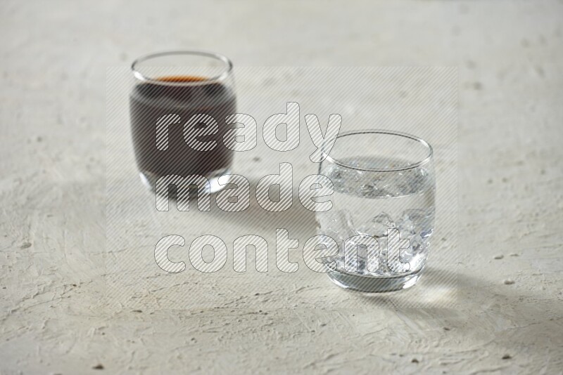 Cold drinks in a glass cup such as water, tamarind, qamar eldin, sobia, milk and hibiscus on textured white background