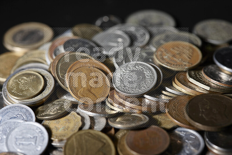 A close-ups of random old coins on black background