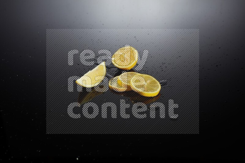 Lemon slices with water drops, and droplets on black background