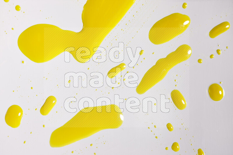 Close-ups of abstract yellow paint droplets on white background
