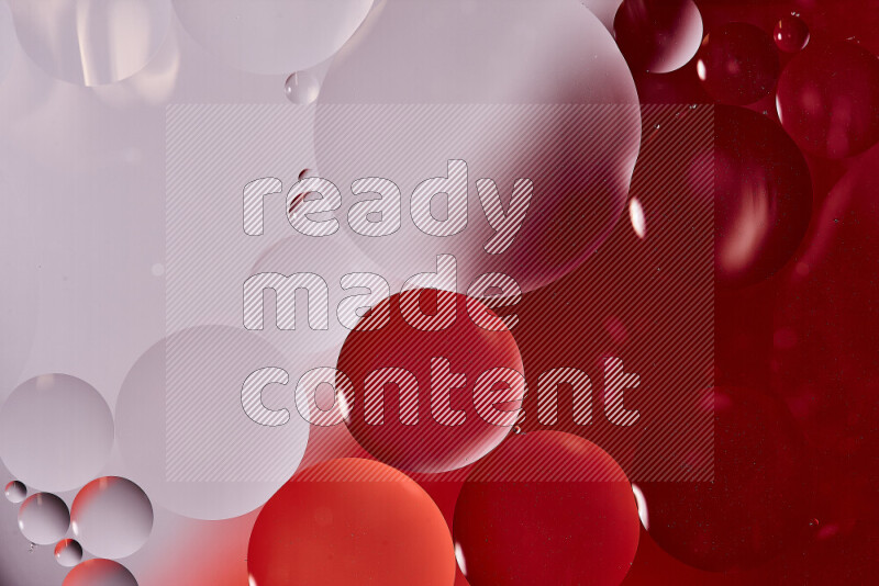 Close-ups of abstract oil bubbles on water surface in shades of white and red