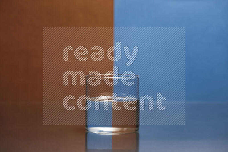 The image features a clear glassware filled with water, set against brown and blue background