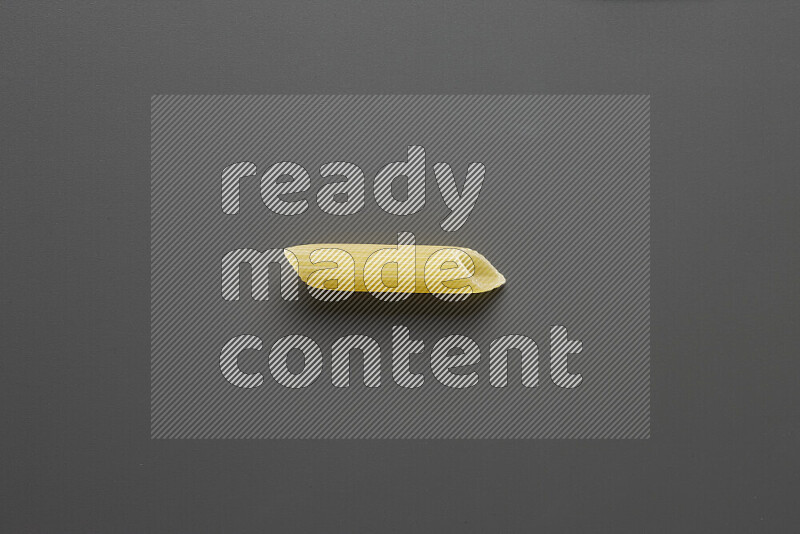Penne pasta on grey background