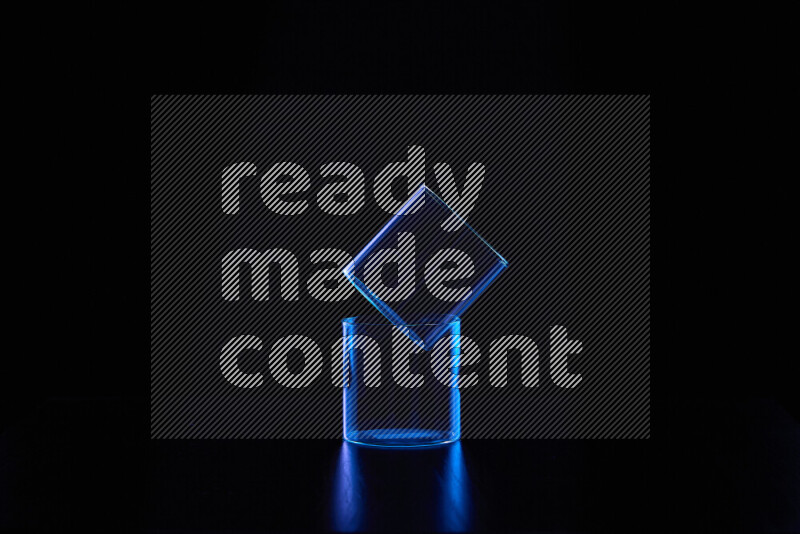 Glassware with rim light in blue against black background