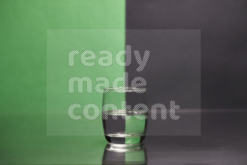 The image features a clear glassware filled with water, set against green and black background
