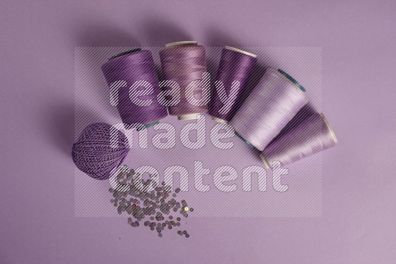 Purple sewing supplies on purple background