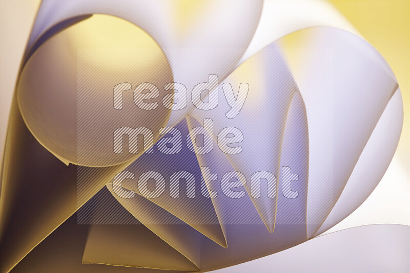 An artistic display of paper folds creating a harmonious blend of geometric shapes, highlighted by soft lighting in white and gold tones