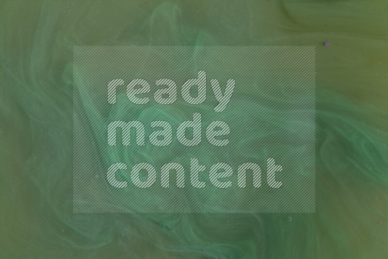 The image captures a dramatic splatter of green paint over a white backdrop