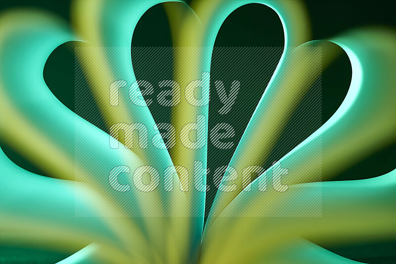 An abstract art piece displaying smooth curves with green gradients created by colored light