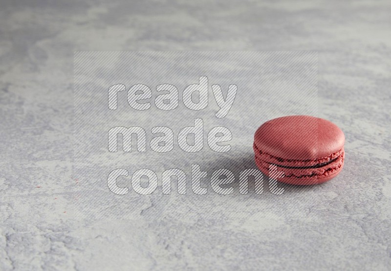 45º Shot of Pink Raspberry macaron on white  marble background