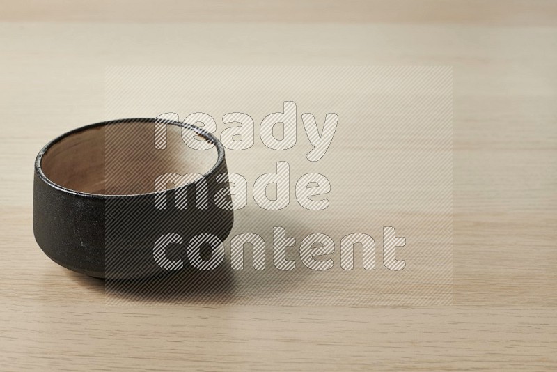 Black Pottery Bowl on Oak Wooden Flooring, 15 degrees