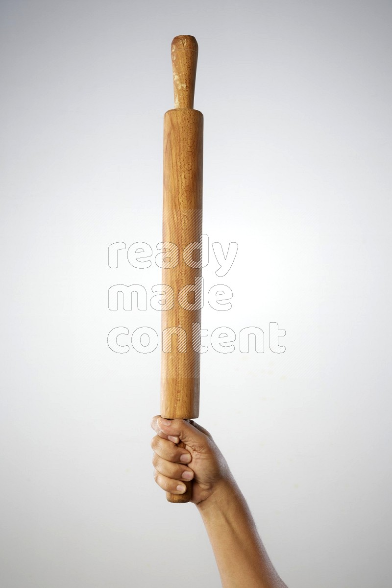 Male Hand Holding Rolling Pin on white background