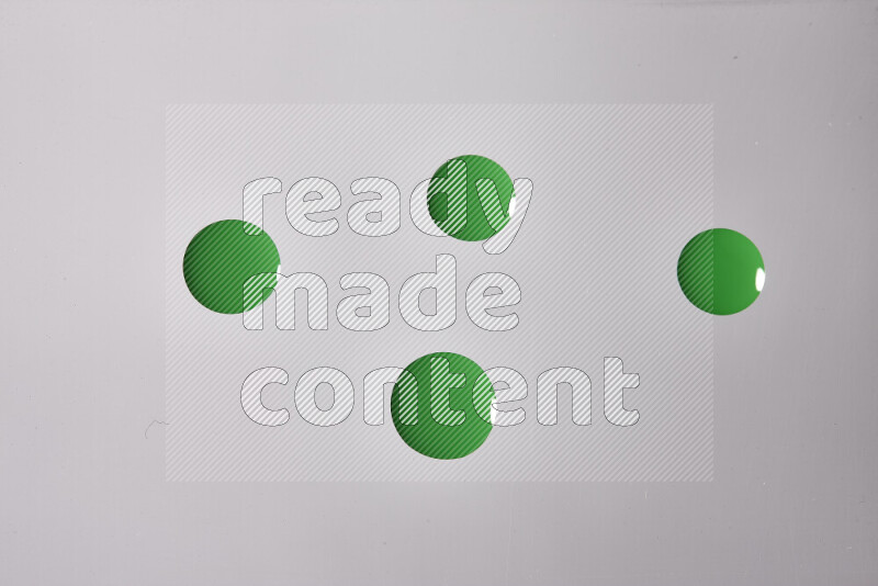 Close-ups of abstract green paint droplets on the surface