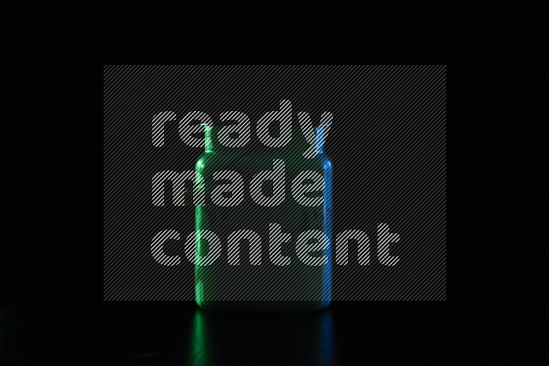 A vintage milk canister with colored rim light against black background