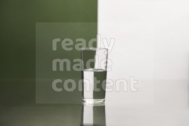 The image features a clear glassware filled with water, set against white and dark green background