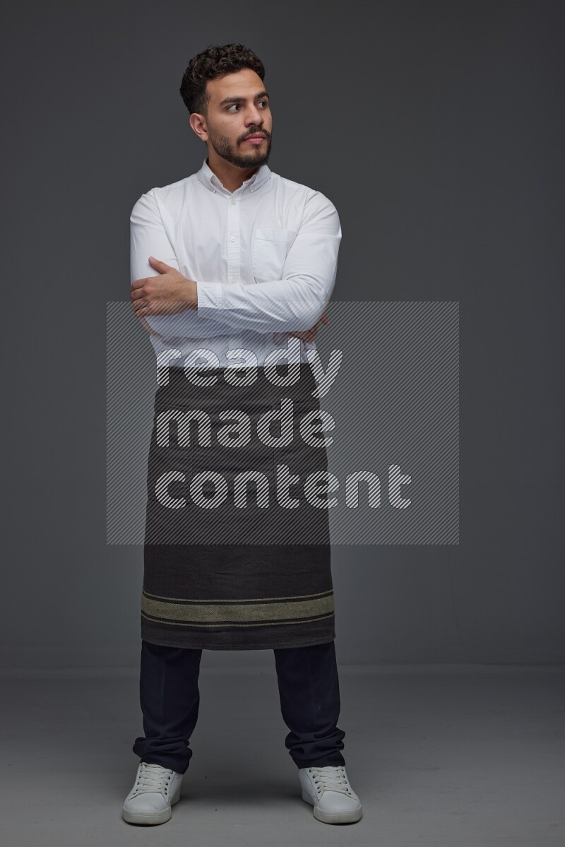 A man wearing smart casual and apron standing and making multi poses eye level on a gray background