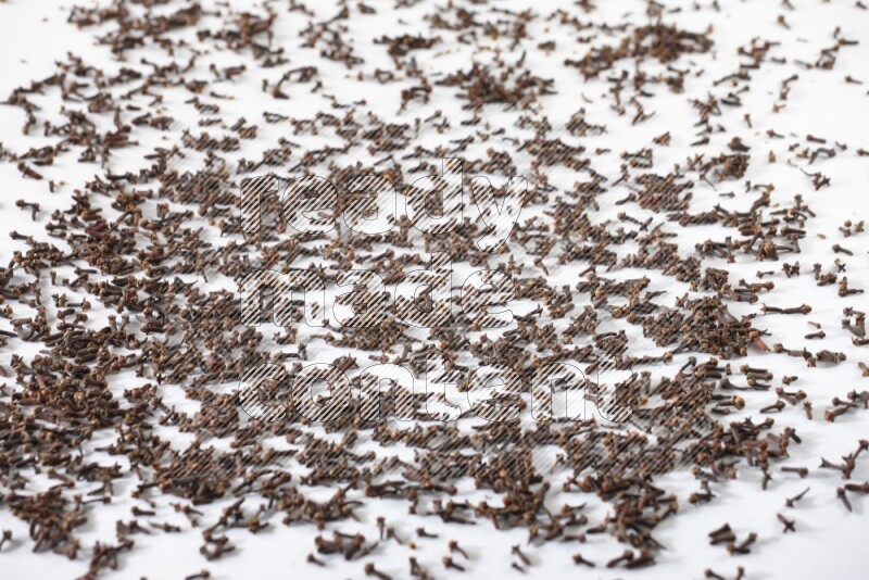 Cloves spread on white flooring