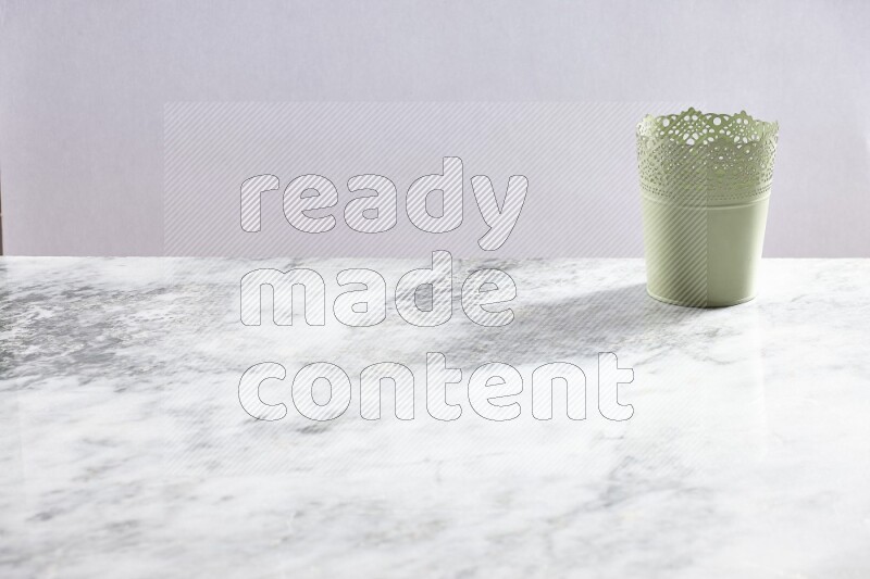 An empty green plant pot on grey marble background