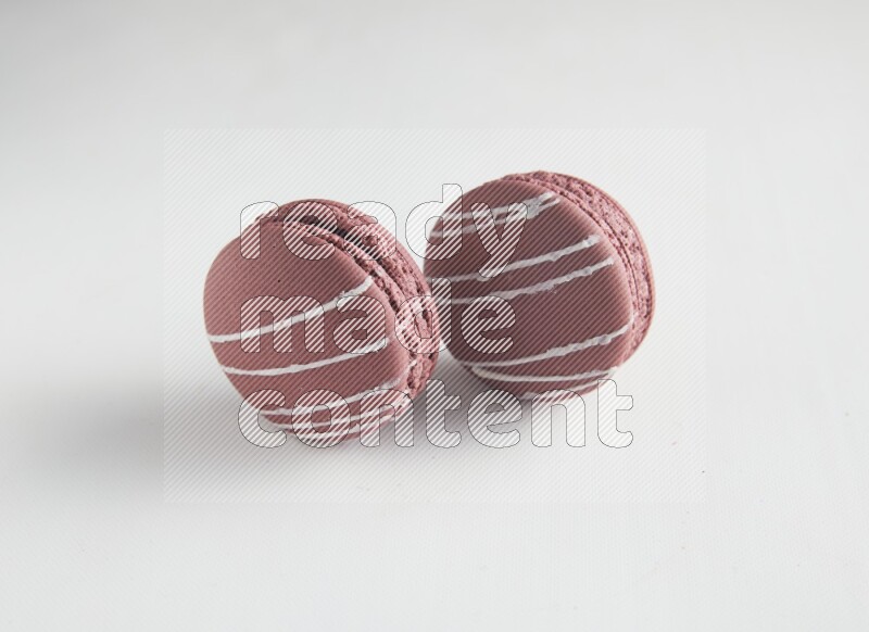 45º Shot of two Red Poppy Flower macarons on white background