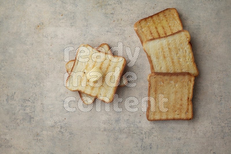 Toasted White Toast slices with a butter curl on a light blue textured background