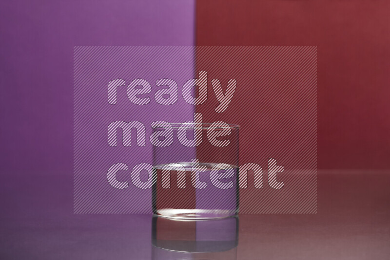 The image features a clear glassware filled with water, set against purple and dark red background