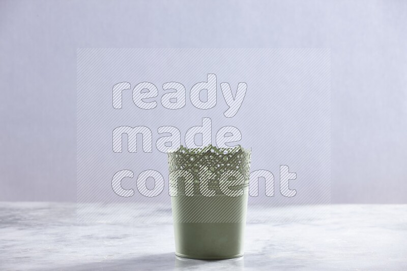 An empty green plant pot on grey marble background