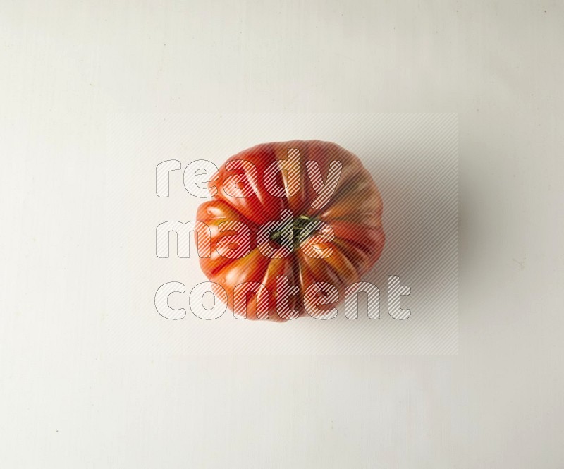 Single topview Heirloom tomato on a white backgrounds