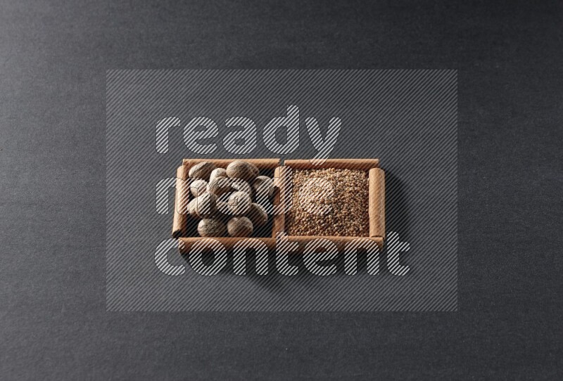 2 squares of cinnamon sticks full of mustard seeds and nutmeg on black flooring