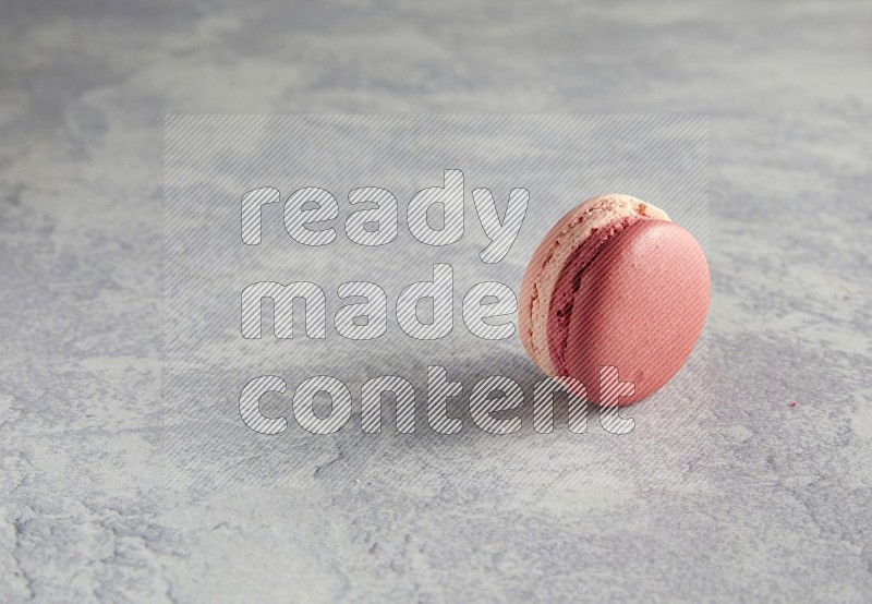 45º Shot of Pink Litchi Raspberry macaron on white  marble background